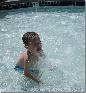 boy splashing in a pool