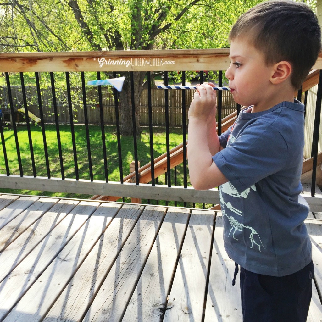 Shooting a straw rocket for straw rocket races - perfect summer fun activity indoor activity or outdoor activity #HelloSummerfun 